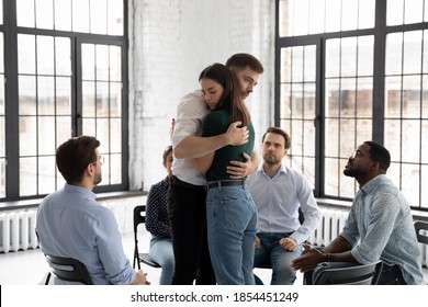 Embraces Of Support. Sad Young Male And Female Patients Of Psychologist Or Rehabilitation Center Hugging One Another With Understanding And Care On Group Therapy Session Sharing Hard Feelings Pressure