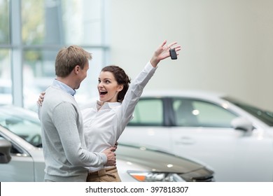 Embracing couple with car keys