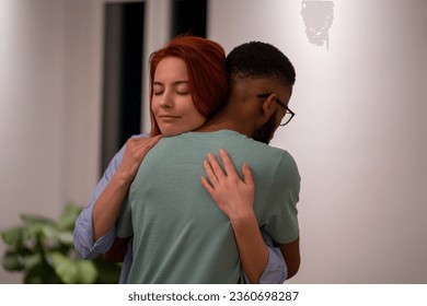 Embracing diverse couple man and woman moment intimacy and love, feelings of support joy or sadness. People in love. Relationships between friends, relatives. Empathetic girl hugging boyfriend. - Powered by Shutterstock