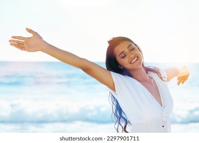 Embracing the freedom. Beautiful woman on the beach with her arms outstretched. - Powered by Shutterstock