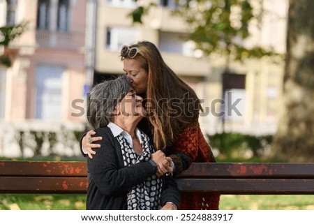 Similar – Young woman talking to elderly woman in wheelchair