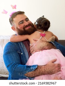 Embracing His Feminine Side For The Love Of His Daughter. Shot Of An Affectionate Little Girl Playing Dress Up With Her Father At Home.