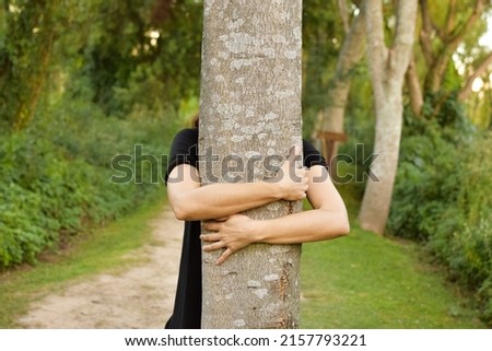 Similar – hands of woman hugging a tree