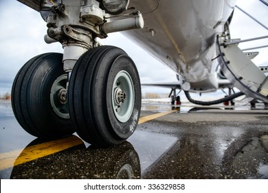 Embraer ERJ 145 aircraft landing gear on the runway - Powered by Shutterstock
