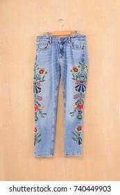 Embroidered, Flowers, Blue Jeans On Hanging-wooden Background