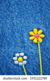 Embroidered Flowers On Fragment Of  Blue Denim Jeans Texture