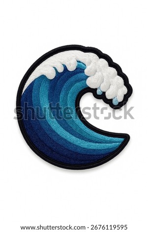 An embroidered patch of a stylized ocean wave. The design features a gradient of blue tones and a white, cresting foam, all bordered by a thick black outline that adds a graphic punch.