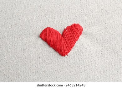 Embroidered red heart on light cloth, top view - Powered by Shutterstock