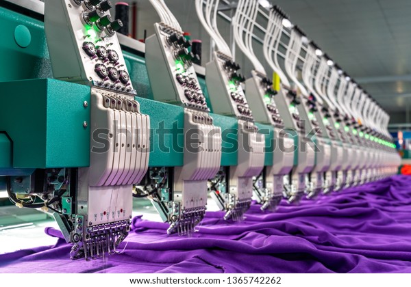 Embroidery area in textile factory in industrial\
zone in Ho Chi Minh City, Vietnam, with modern machinery and\
technology systems.