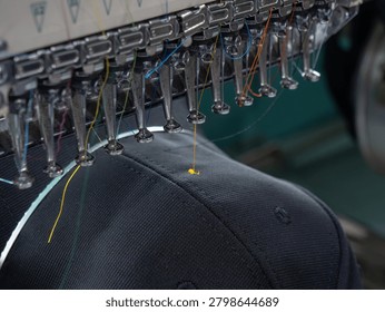 Embroidery caps in progress by Computerized machine embroidery in Textile Industry at Garment Manufacturers