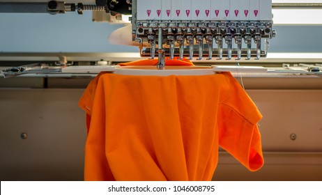 Embroidery Machine From The Front, Stiching A Orange Poloshirt