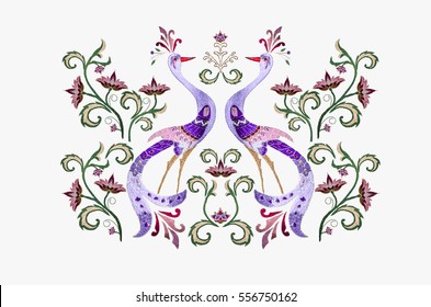 Embroidery stylized birds among  branch with purple red  flowers and twisted leaves on white background.