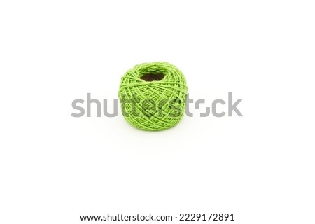 Embroidery thread roll in greenyellow color on white background