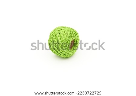 Embroidery thread roll in greenyellow color on white background
