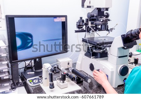 Embryologist adding sperm to egg in laboratory of reproductive clinic. Selective focus