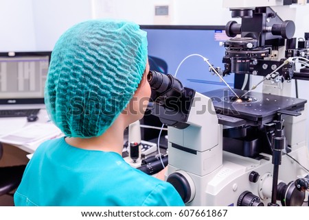 Embryologist adding sperm to egg in laboratory of reproductive clinic. Selective focus
