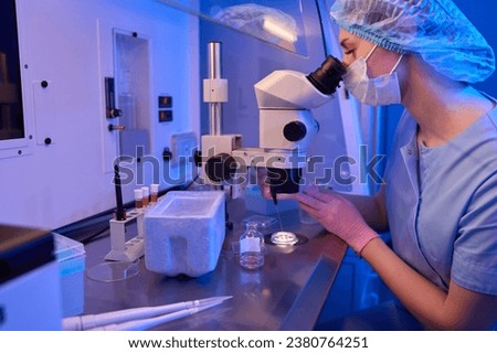 Embryologist preparing cell samples for cryopreservation procedure