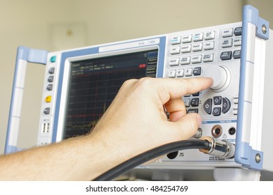 EMC engineer hand adjusting laboratory test receiver