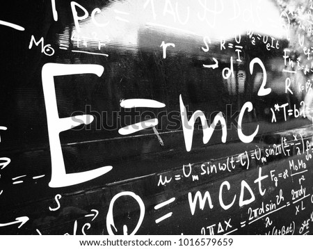 Emc2 formula on black wall. Science background image.