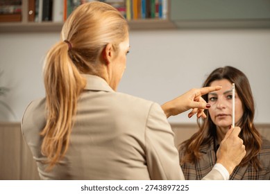 EMDR session applying pen-based eye movement to activate bilateral brain stimulation. Shows focused visual engagement and clinical safety.