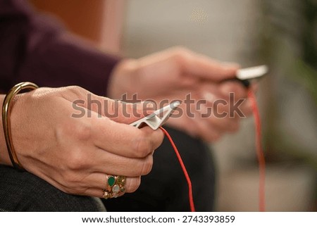 EMDR therapy using a pulsator device to produce alternating vibration tactile cues. Shows bilateral engagement, structured delivery, and trauma-informed treatment.
