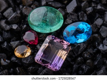 Emerald gemstone and blue quartz with dark rock background.