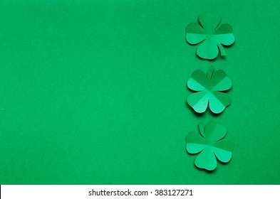 Emerald green paper clover shamrock leafs border frame on background. St. Patrick's Day postcard template. Space for copy, lettering, text.