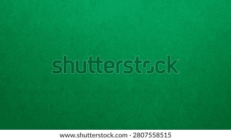 Emerald green paper texture background with soft grain and natural light falloff