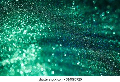 Emerald green shiny defocused lights bokeh background. 