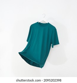 Emerald green tshirt with hanger on white background - Shutterstock ID 2095202398
