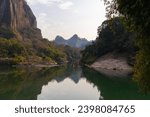 The emerald green water of the Nine Bend River or Jiuxi river through Wuyishan or mount wuyi scenic area in Fujian Province China. Sunset background
