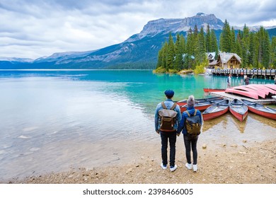 Emerald Lake Yoho National Park Canada British Colombia. a beautiful lake in the Canadian Rockies during the autumn season. A couple of men and women standing by the lake looking at the mountains - Powered by Shutterstock