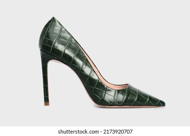 Emerald pointy toe women's shoes with high heels isolated on white background. Green Female classic stiletto heels in crocodile skin leather. Single. Mock up, template