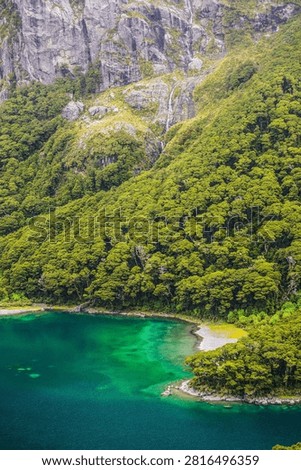 Emerald waterscape. Whispering cliffs. Forest embrace