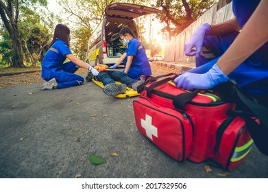 Emergency accident patient Suffered on head lying on stretcher. First aid training and move patient in emergency accident. Paramedic transfer patient to ambulance car. Select Focus on first aid bag.