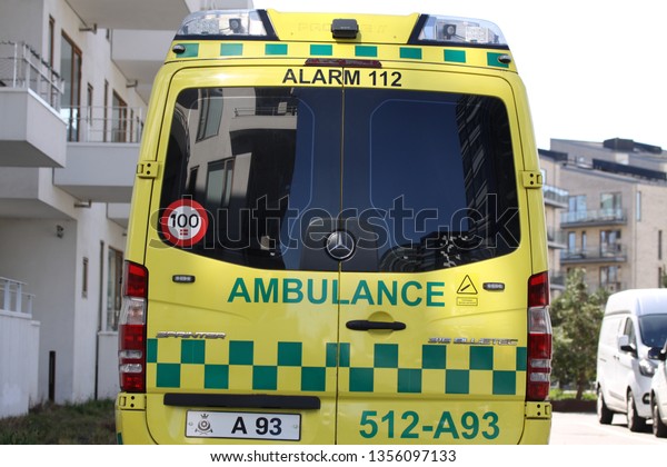 Emergency ambulance vehicle parked seen\
from rear. Copenhagen, Denmark -  April 1, 2019\
