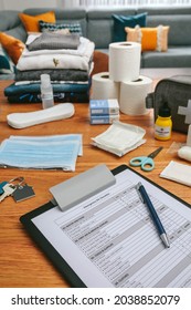 Emergency backpack checklist with necessities prepared in the living room - Shutterstock ID 2038852079