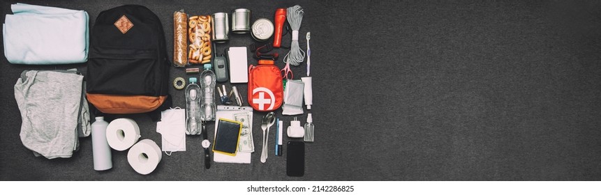 Emergency Backpack Equipment Organized On The Table. Documents, Water,food, First Aid Kit And Another Items Needed To Survive.