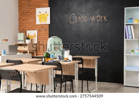 Emergency backpack and necessities on table in empty classroom