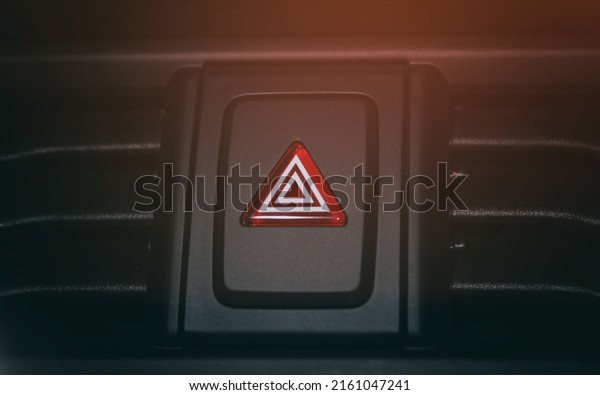 Emergency button on the car panel. The button for
turning off, turning on the emergency mode in the car. Background,
car emergency button.
