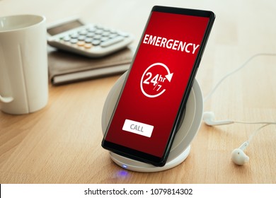 Emergency Call Concept. Mobile Smartphone Is Placed On A Wireless Fast Charger.