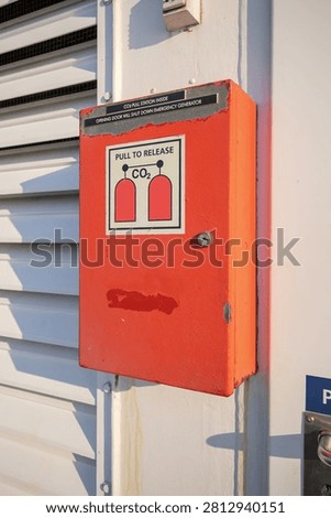 Emergency CO2 fire suppression pull station box on utility wall