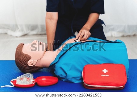 Emergency CPR Training on dummy , nurse using stethoscope to checking breat on unconscious person, One part of the process resuscitation.