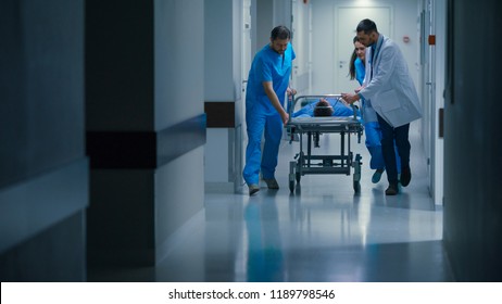 Emergency Department: Doctors, Nurses and Paramedics Push Gurney / Stretcher with Seriously Injured Patient towards the Operating Room. Bright Modern Hospital with Professional Staff Saving Lives.