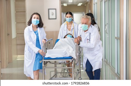 Emergency Department: Doctors and Paramedics Push Gurney.  Stretcher with Seriously Injured Patient towards the Operating Room. health care, reanimation and medicine concept - Powered by Shutterstock