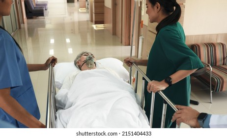 Emergency Department. Nurse and senior doctor team busy push emergency stretcher transport senior patient in hospital, doctors, nurses in surgical gown and white coat uniform running with hurry - Powered by Shutterstock