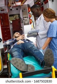 Emergency Doctor Asking Patient To Sign In Logbook At Ambulance Car