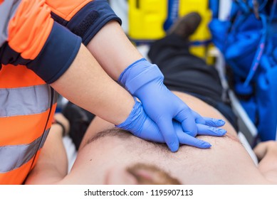 Emergency Doctor Resuscitate A Patient In Ambulance. CPR Resuscitation.