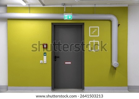 Emergency door with exit, elevator, stairs symbols