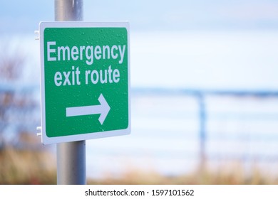 Emergency Escape Route Green Sign With Direction Arrow